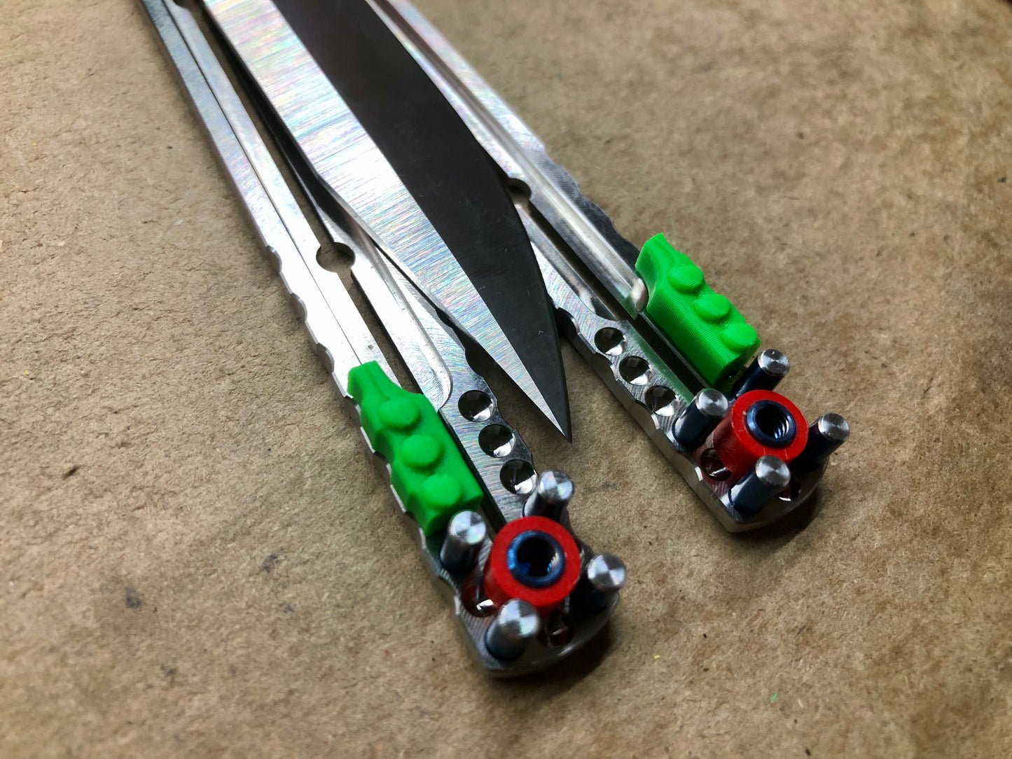 These Zippy spacers are designed for the Squid Industries Titanium Krake Raken and provide a "block spacer" aesthetic. The spacers feature an innovative "segmented" geometry, allowing full integration with the stock weight-pin system and endless balance and ergo configurations to fine-tune the weight distribution to your preference. The Zippy spacers also remedy the stock slab offset (i.e., spacer thickness) of the Ti Krake to establish improved handle parallelism for the best tune possible.