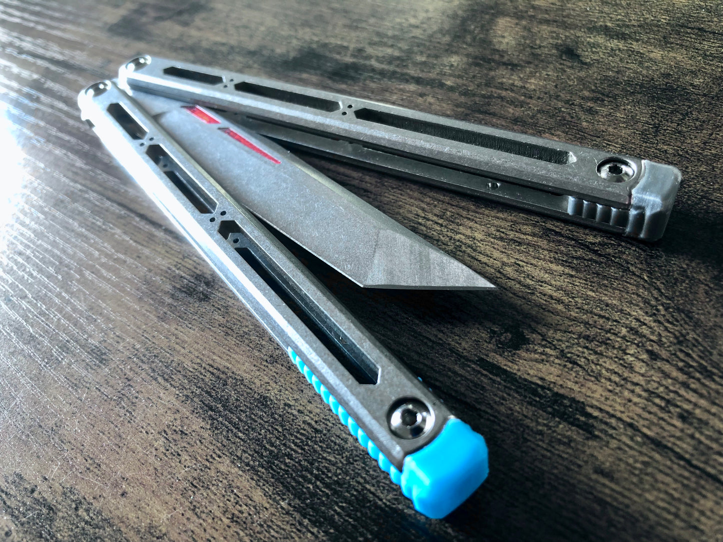 These Zippy spacers designed for the Squid Industries Hydro Balisong are made in-house from a rubbery, shatter-proof polyurethane. They add positive "sawtooth" jimping to the Hydro and are available as either full-length flush spacers for a more neutral balance, or handle extensions (with an adjustable tungsten weight system) to protect the handles from drops and increase momentum. A cosmetic blade insert is included.