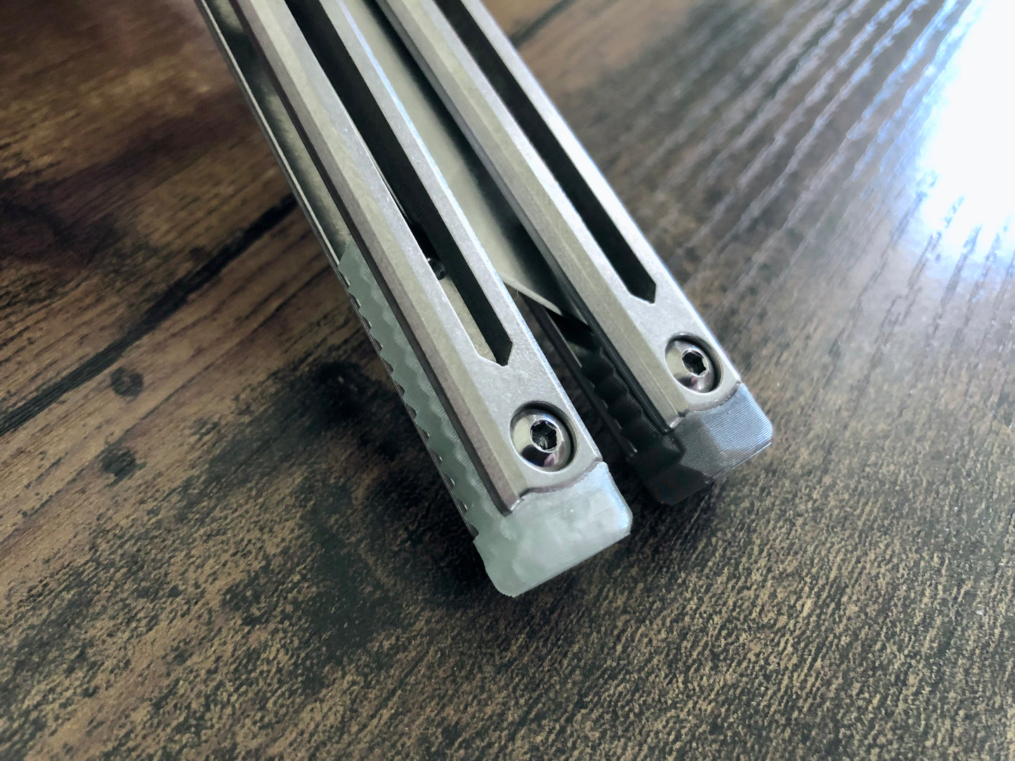 These Zippy spacers designed for the Squid Industries Hydro Balisong are made in-house from a rubbery, shatter-proof polyurethane. They add positive "sawtooth" jimping to the Hydro and are available as either full-length flush spacers for a more neutral balance, or handle extensions (with an adjustable tungsten weight system) to protect the handles from drops and increase momentum. A cosmetic blade insert is included.