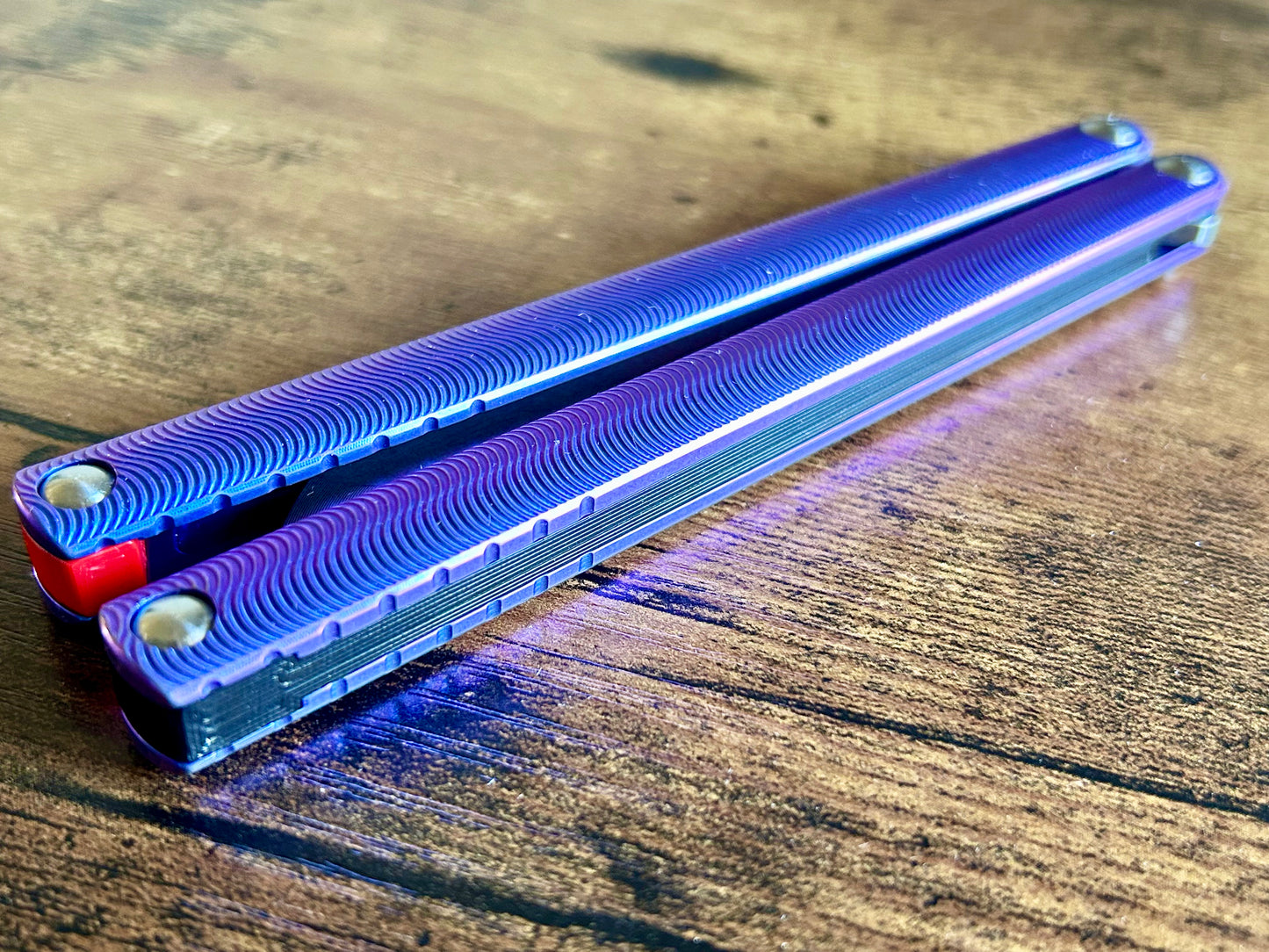 Zippy Faux-Channel Spacers for the MachineWise Tottori add a channel aesthetic to your butterfly knife. They are made of polycarbonate and cannot be pushed in.