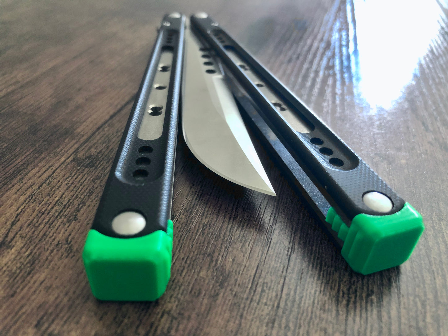 These Black Balisong Rebola v2 spacers are made in-house from a rubbery, shatter-proof polyurethane. They are ultra-lightweight extension spacers that reduce the stock handle-bias. They also feature positive sawtooth jimping and enable adjustable balance with up to 1x removable tungsten weight per spacer.
