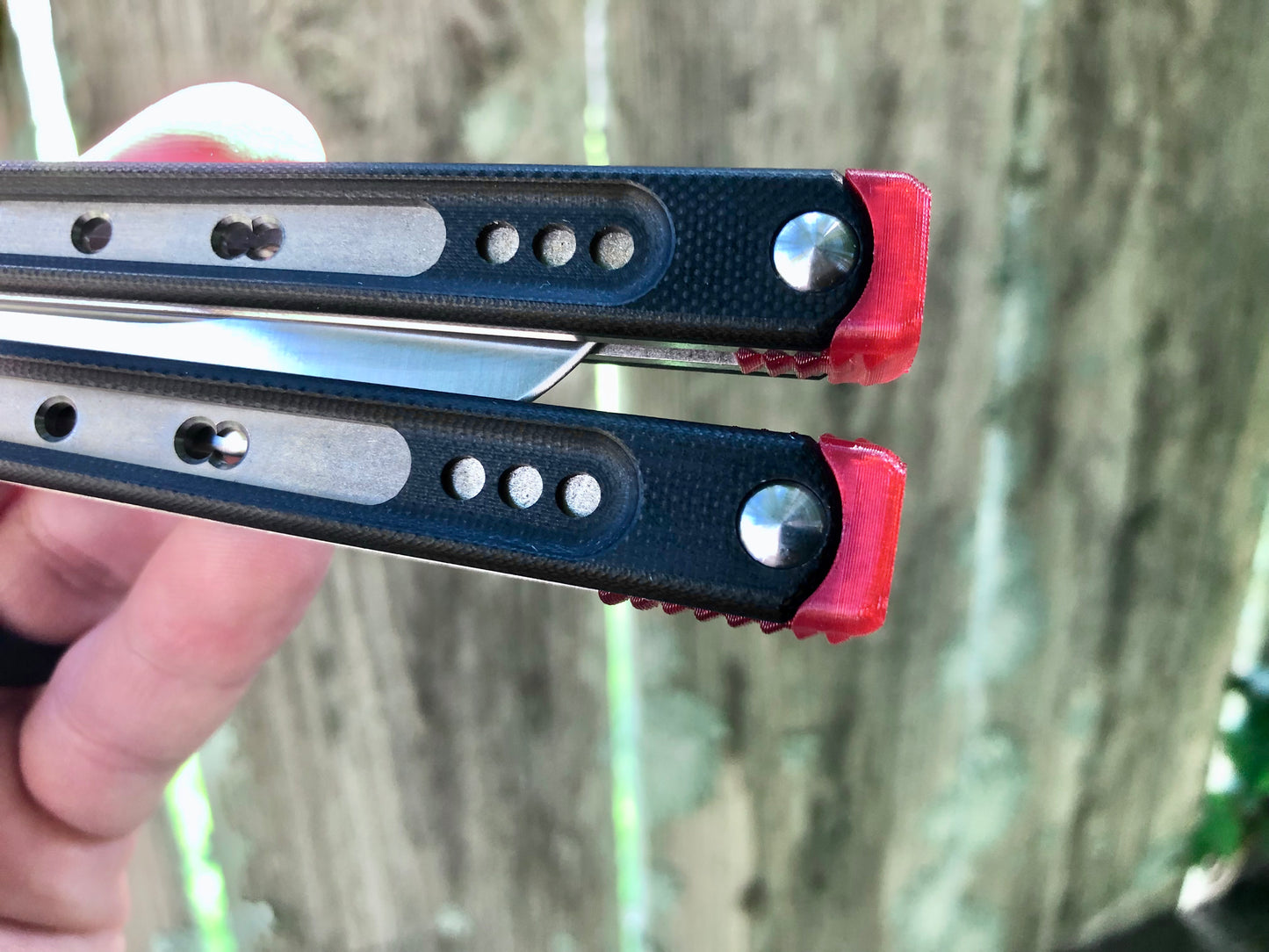 These Black Balisong Rebola v2 spacers are made in-house from a rubbery, shatter-proof polyurethane. They are ultra-lightweight extension spacers that reduce the stock handle-bias. They also feature positive sawtooth jimping and enable adjustable balance with up to 1x removable tungsten weight per spacer.