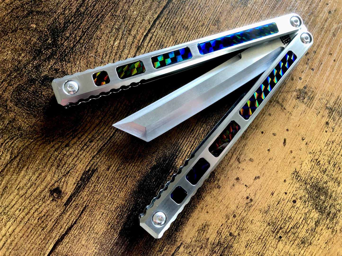 Modify the ergo, deepen the sound, and add a pop of color to your B.A. Balis Tesseract balisong with these polyurethane Zippy handle inlays.