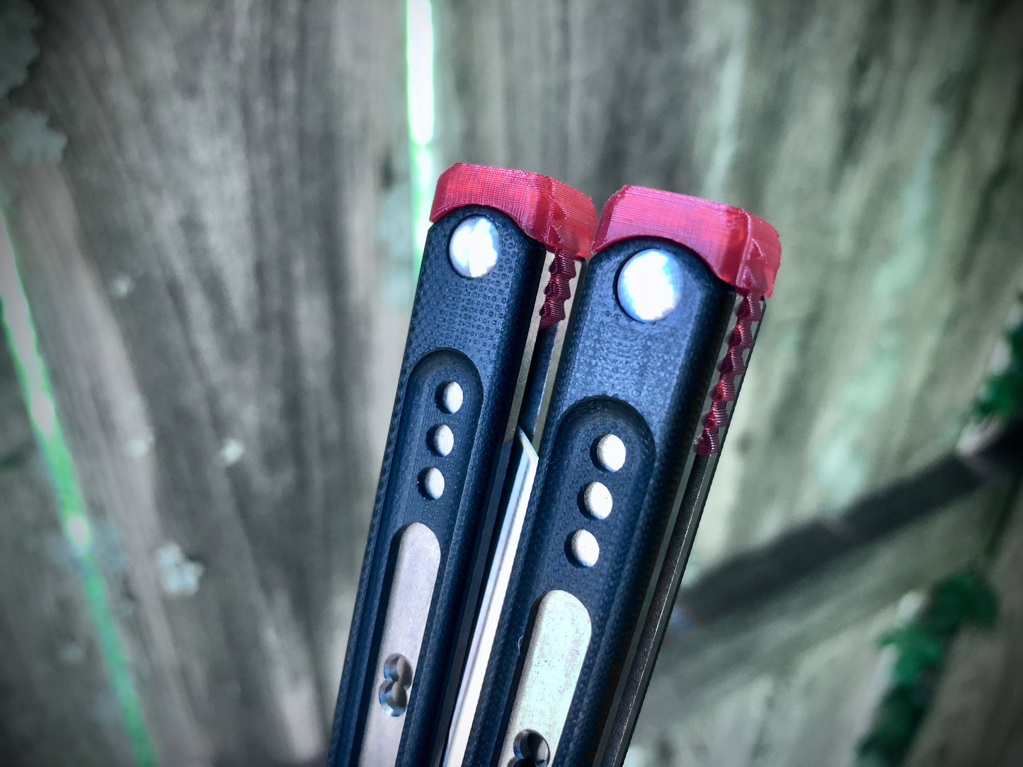 These Black Balisong Rebola v2 spacers are made in-house from a rubbery, shatter-proof polyurethane. They are ultra-lightweight extension spacers that reduce the stock handle-bias. They also feature positive sawtooth jimping and enable adjustable balance with up to 1x removable tungsten weight per spacer.