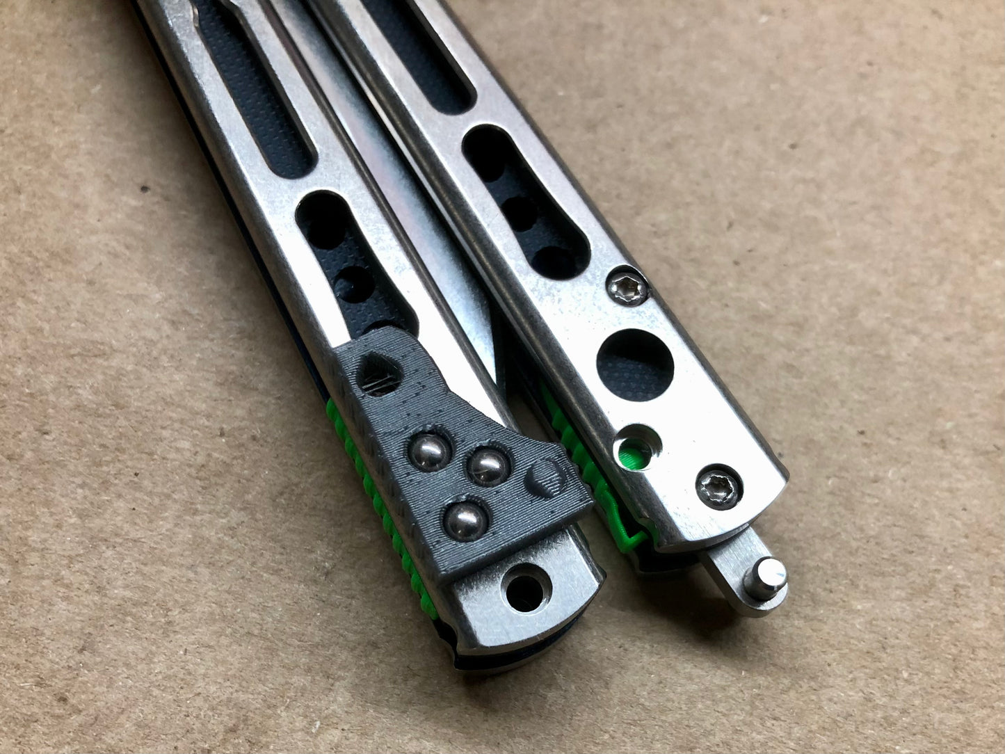 Make your HOM Chimera balisong a more neutral flipper with Zippy spacers: full-length spacers with jimping, or spring-latch spacers that counterweight the safe handle for improved balance.