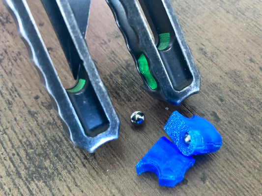 Silence the ring and adjust the weight distribution of your Nabalis Canyon balisong these custom-made Zippy inlays