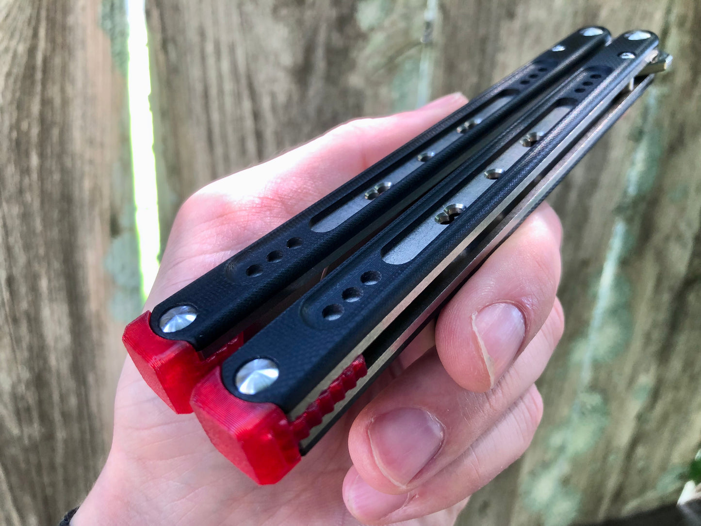 These Black Balisong Rebola v2 spacers are made in-house from a rubbery, shatter-proof polyurethane. They are ultra-lightweight extension spacers that reduce the stock handle-bias. They also feature positive sawtooth jimping and enable adjustable balance with up to 1x removable tungsten weight per spacer.