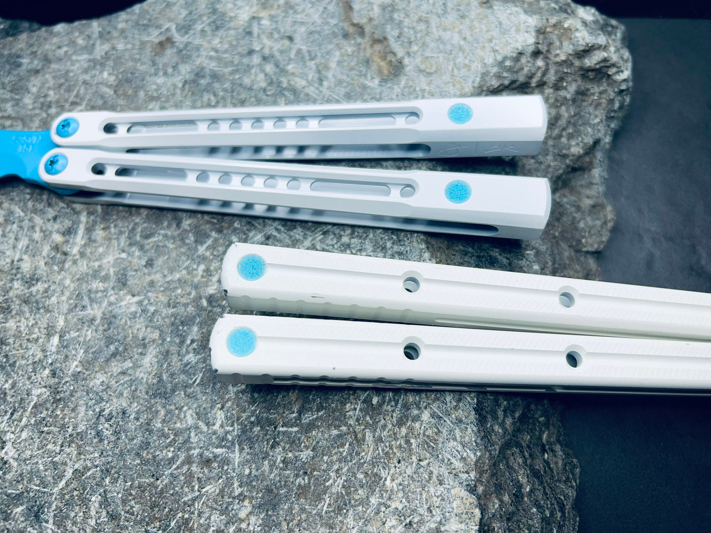 Pivot Plugs are a cosmetic handle inlay mod designed to friction fit in 3/16" bores at the bottom of a variety of balisong handles, including the Squid Industries Krake Raken balisong, the MachineWise Prysma, and the Nabalis Vulp Pro.