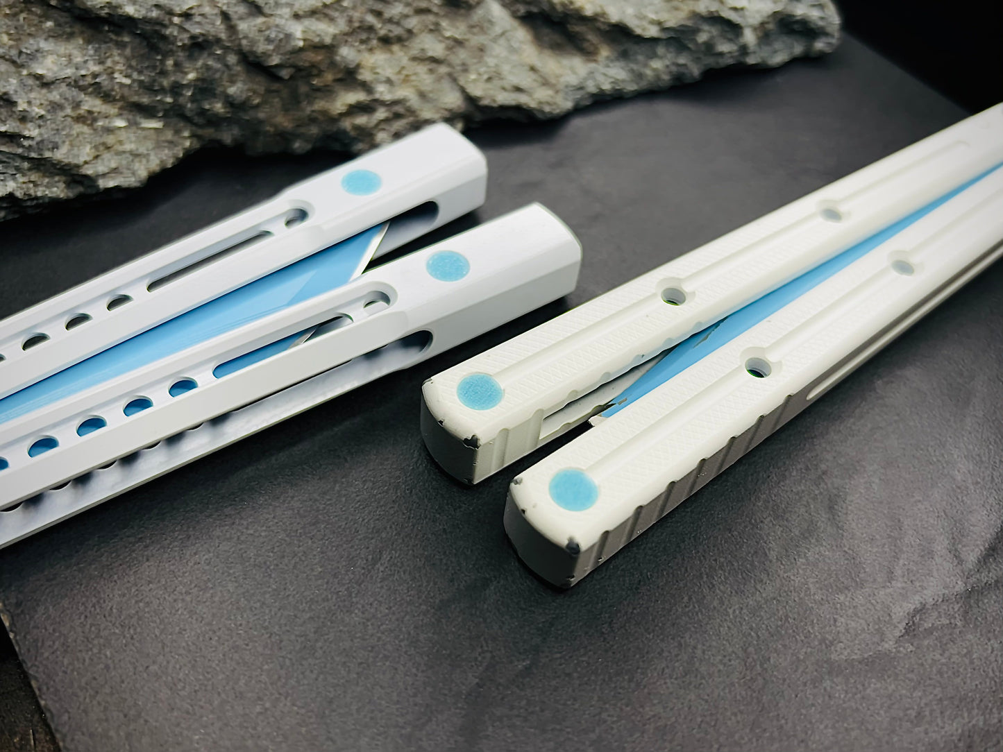 Pivot Plugs are a cosmetic handle inlay mod designed to friction fit in 3/16" bores at the bottom of a variety of balisong handles, including the Squid Industries Krake Raken balisong, the MachineWise Prysma, and the Nabalis Vulp Pro.