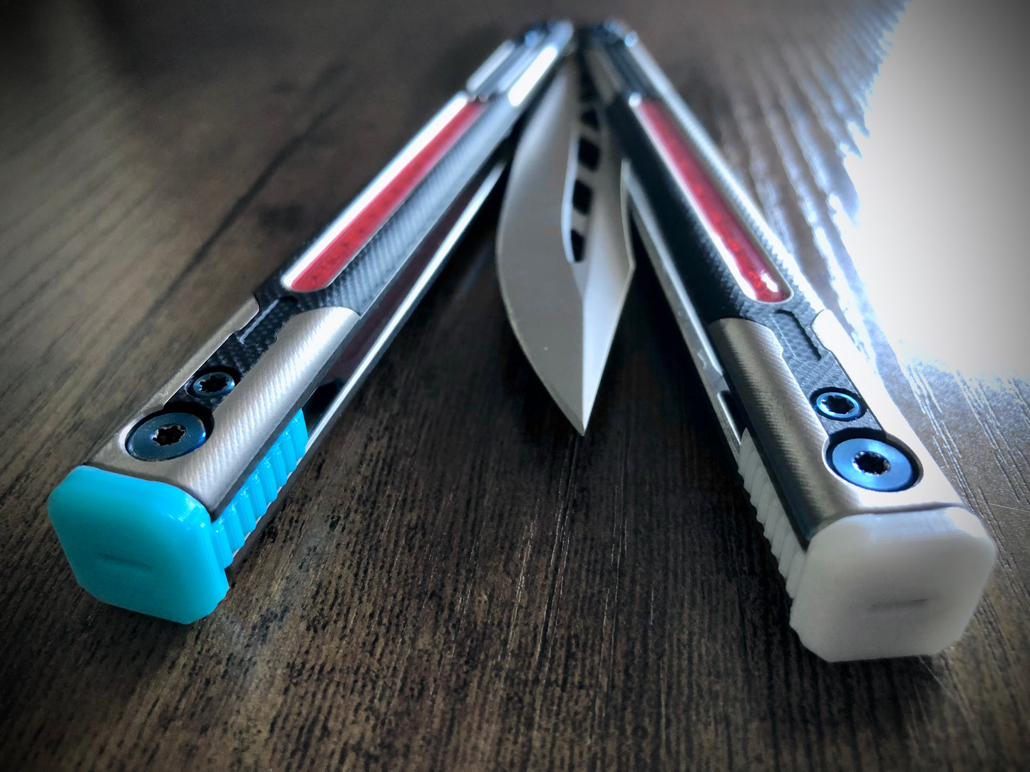 Adjust the balance, extend the handles, and add grip to your LDY balisong Cygnus and Orion flippers with Zippy extension spacers and handle inlays.