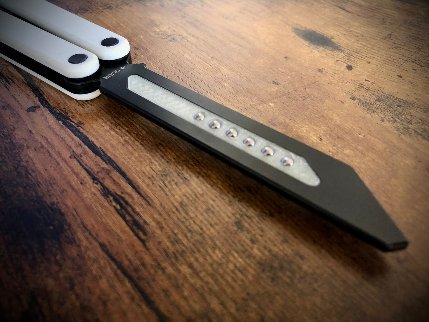 Reduce the handle bias and adjust the balance of your Glidr Arctic, Antarctic, and Bermuda balisong trainers with tungsten-weighted Zippy blade inserts and spacers featuring adjustable balance and positive jimping.