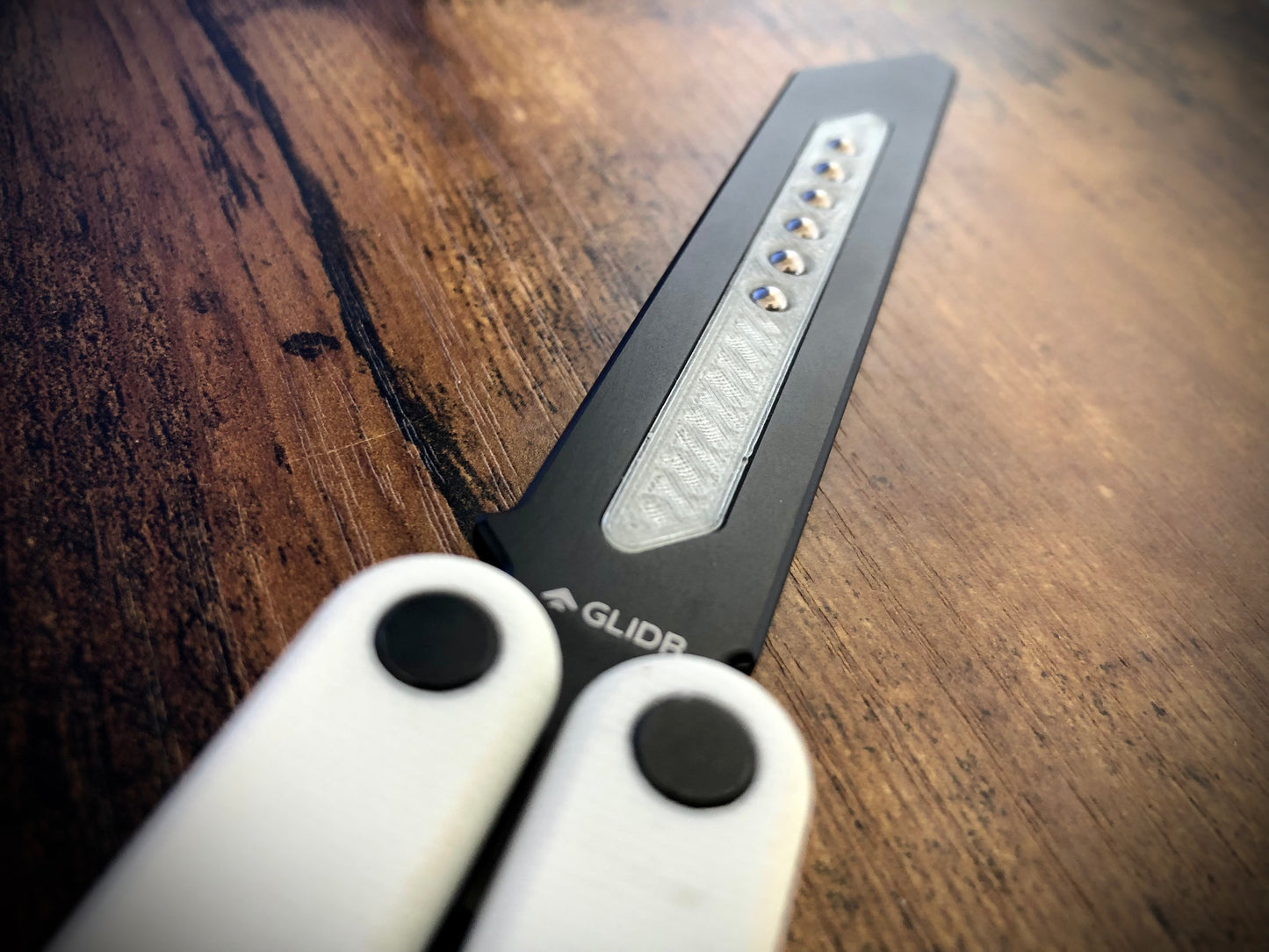 Reduce the handle bias and adjust the balance of your Glidr Arctic, Antarctic, and Bermuda balisong trainers with tungsten-weighted Zippy blade inserts and spacers featuring adjustable balance and positive jimping.