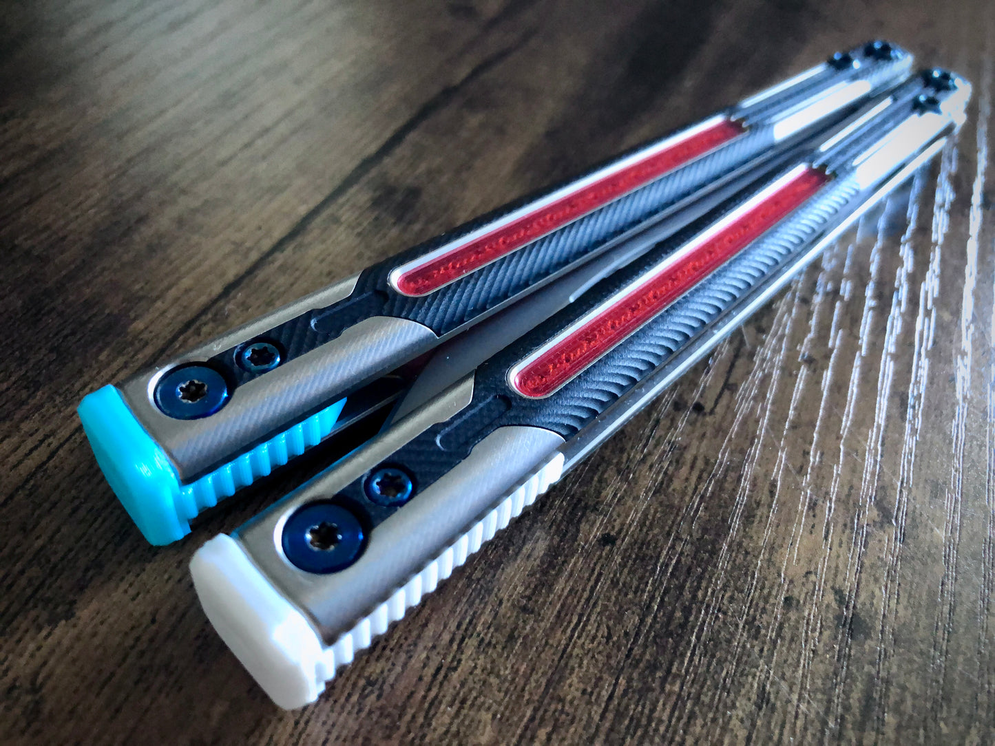 Adjust the balance, extend the handles, and add grip to your LDY balisong Cygnus and Orion flippers with Zippy extension spacers and handle inlays.