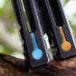 Pivot Plugs are a cosmetic handle inlay mod designed to friction fit into 3/16" bores at the bottom of a variety of balisong handles, including the Squid Industries Krake Raken balisong, the MachineWise Prysma, SliftT, the Nabalis Vulp Pro, and the Acidwrx Zzzyzx.