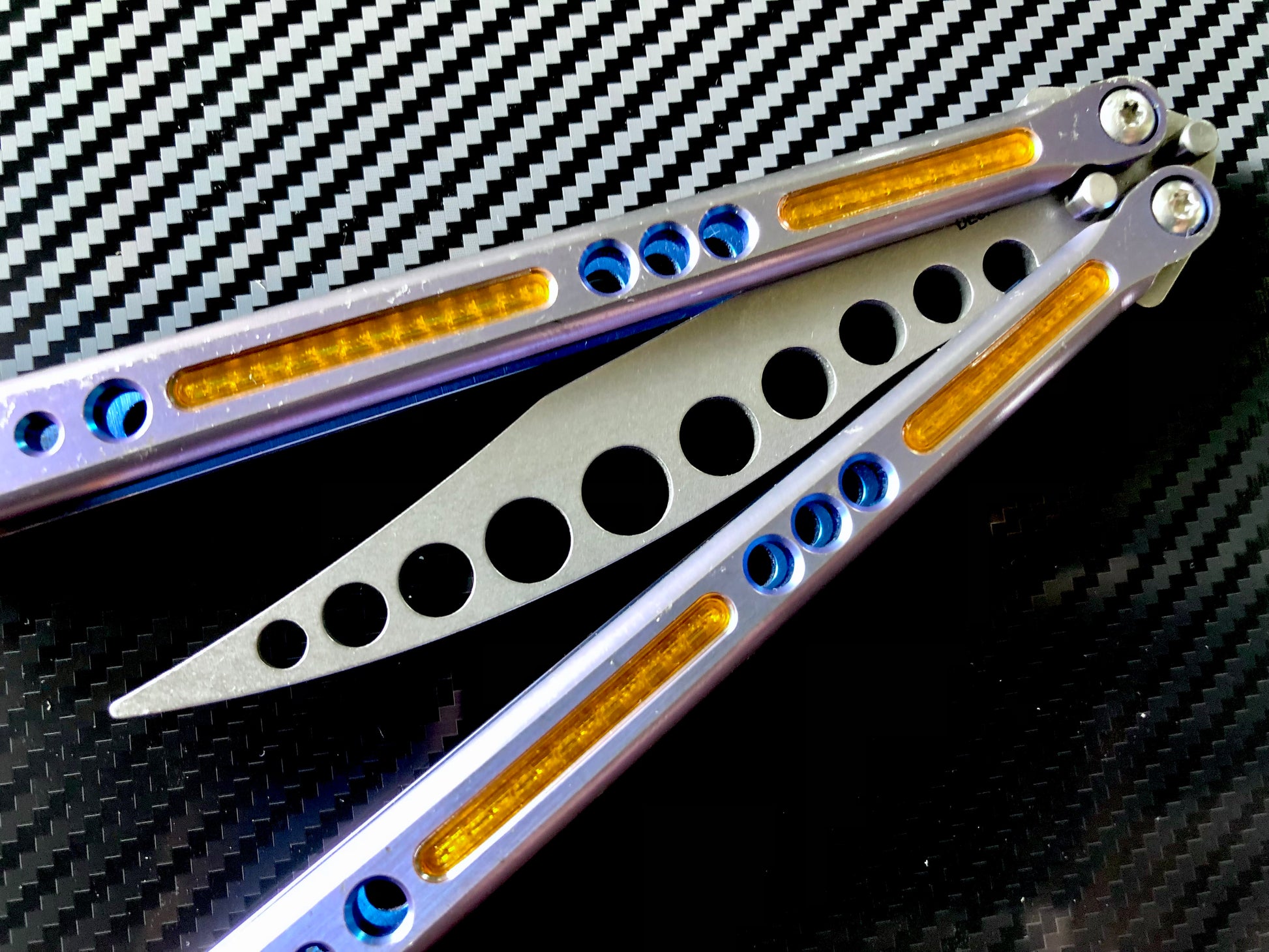 Deepen the sound, modify the grip, and add a pop of color to your HOM Prodigy Mod C balisong trainer with these polyurethane Zippy handle inlays.