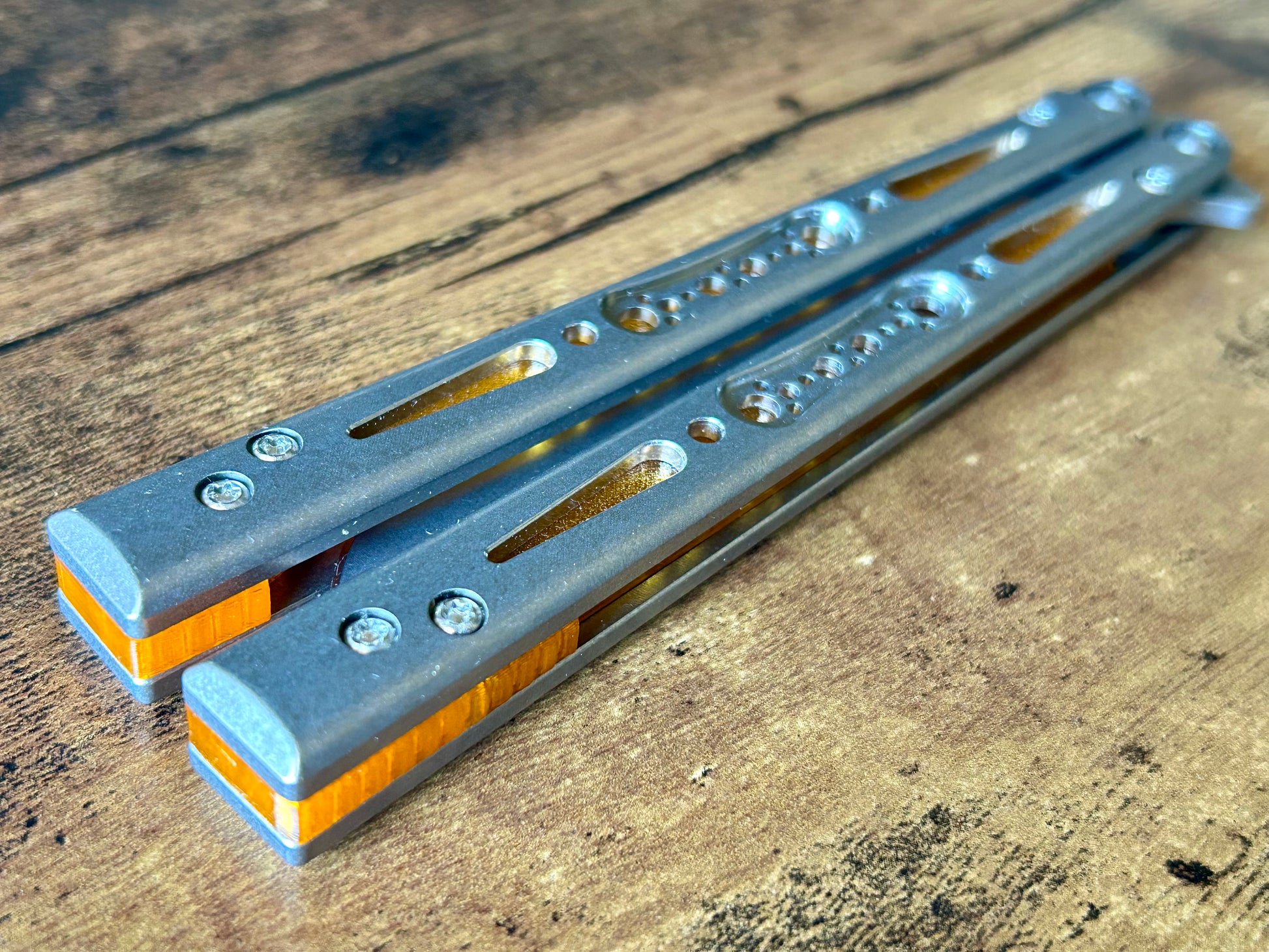 Modify the balance and ergo of your EPS Wraith Balisong with Zippy spacers, made in-house from a rubbery, shatter-proof polyurethane. Compatible with both G10 and Titanium variants. The spacers add positive "saw-tooth" jimping to the Wraith and include a tungsten weight system for adjustable balance. The spacers are available as either full-length flush spacers, or handle extensions which add length and protect the handles from drops.