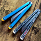 These Zippy spacers designed for the Fellowship Blades Gaboon and Invar Gaboon balisongs are made in-house from a rubbery, shatter-proof polyurethane. They add additional jimping to the Gaboon, provide a more neutral balance, and are also available as extensions which add handle length, protect the handles from drops, and include an adjustable tungsten weight system.
