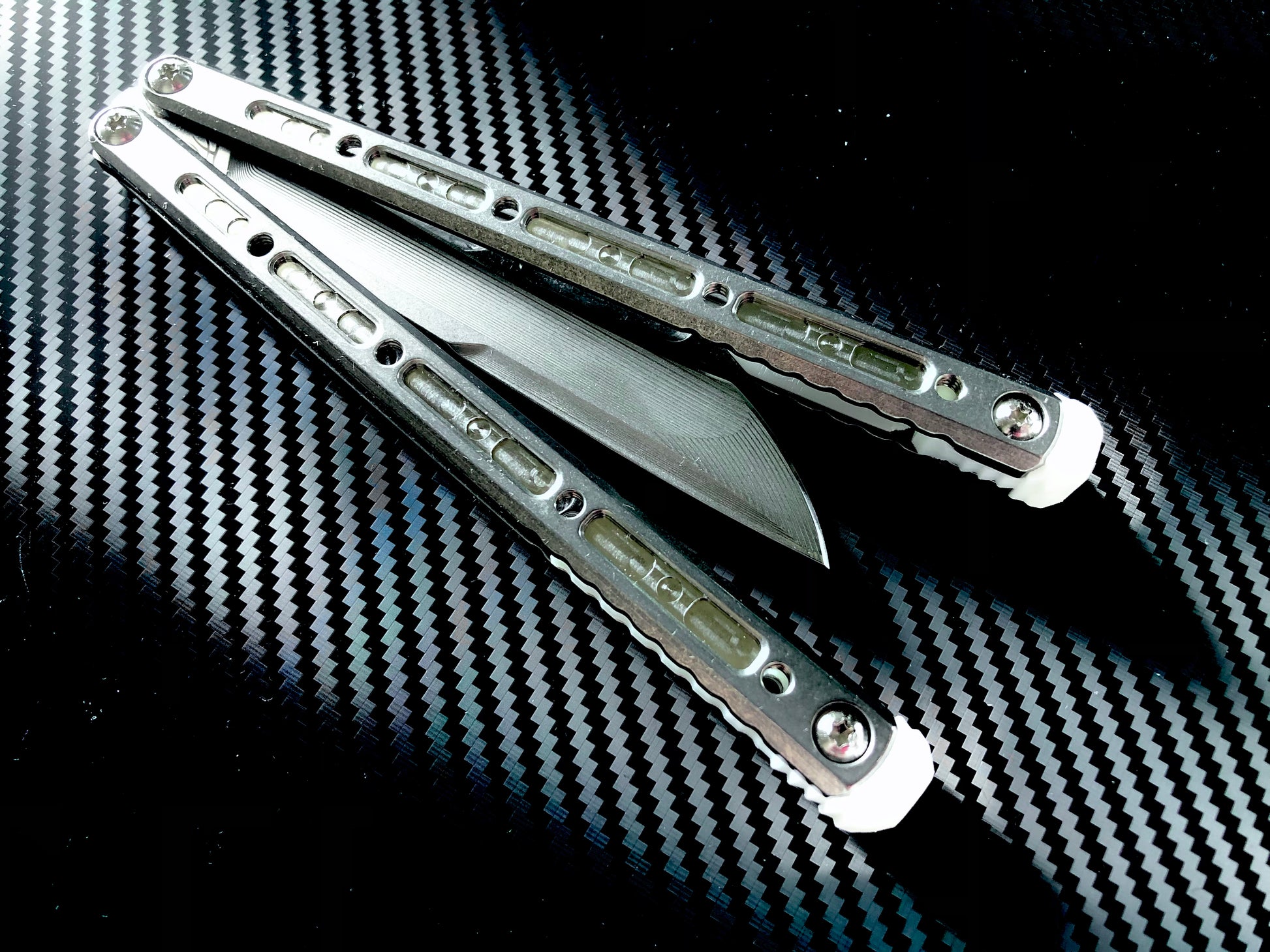 These Zippy spacers designed for the Fellowship Blades Gaboon and Invar Gaboon balisongs are made in-house from a rubbery, shatter-proof polyurethane. They add additional jimping to the Gaboon, provide a more neutral balance, and are also available as extensions which add handle length, protect the handles from drops, and include an adjustable tungsten weight system.