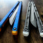 These Zippy spacers designed for the Fellowship Blades Gaboon and Invar Gaboon balisongs are made in-house from a rubbery, shatter-proof polyurethane. They add additional jimping to the Gaboon, provide a more neutral balance, and are also available as extensions which add handle length, protect the handles from drops, and include an adjustable tungsten weight system.