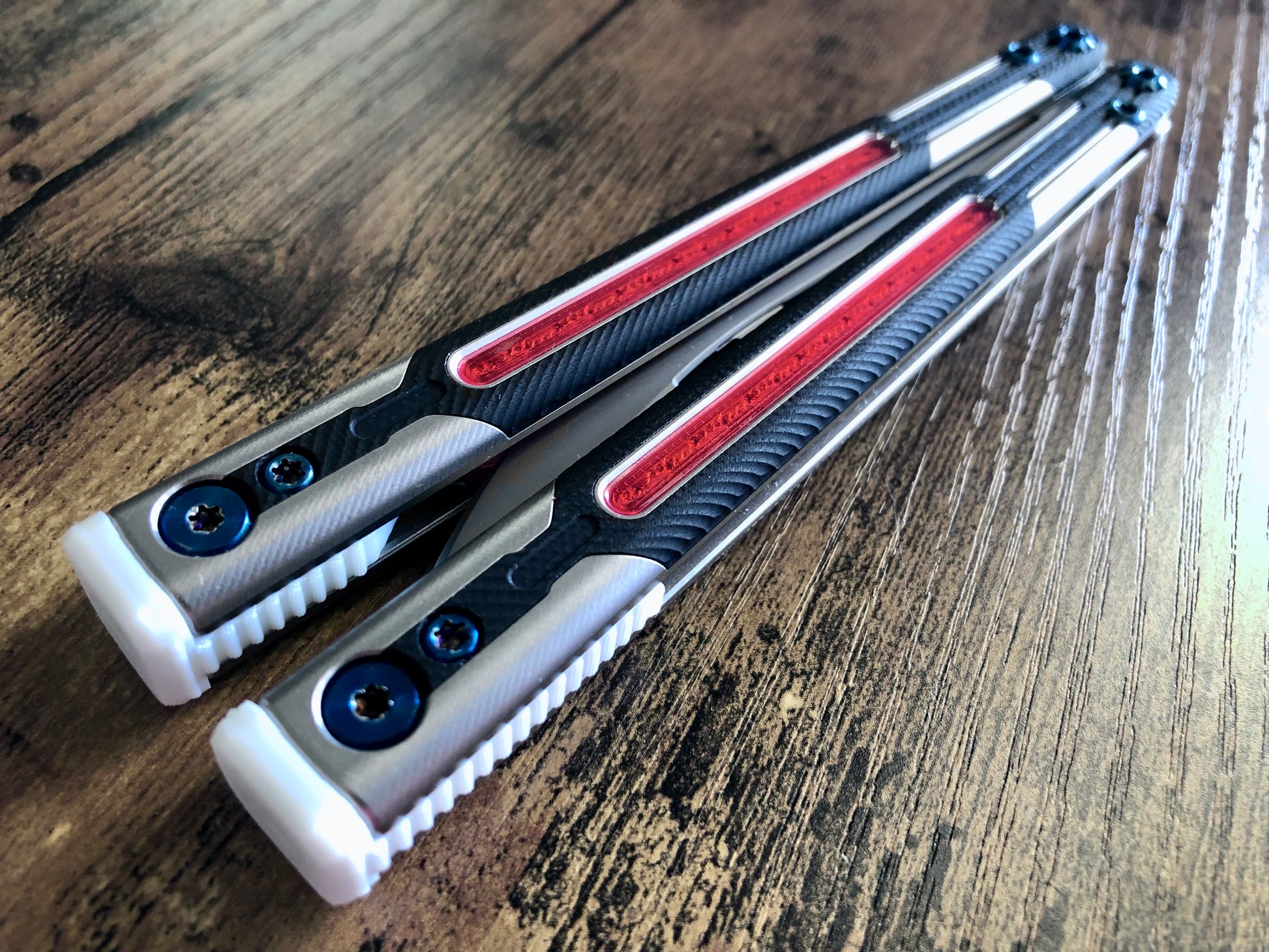 Adjust the balance, extend the handles, and add grip to your LDY balisong Cygnus and Orion flippers with Zippy extension spacers and handle inlays.