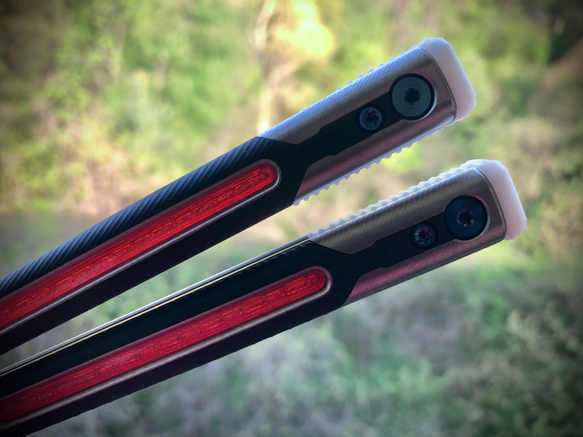 Adjust the balance, extend the handles, and add grip to your LDY balisong Cygnus and Orion flippers with Zippy extension spacers and handle inlays.